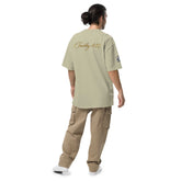 Man wearing oversized signature tee in relaxed streetwear style against plain background