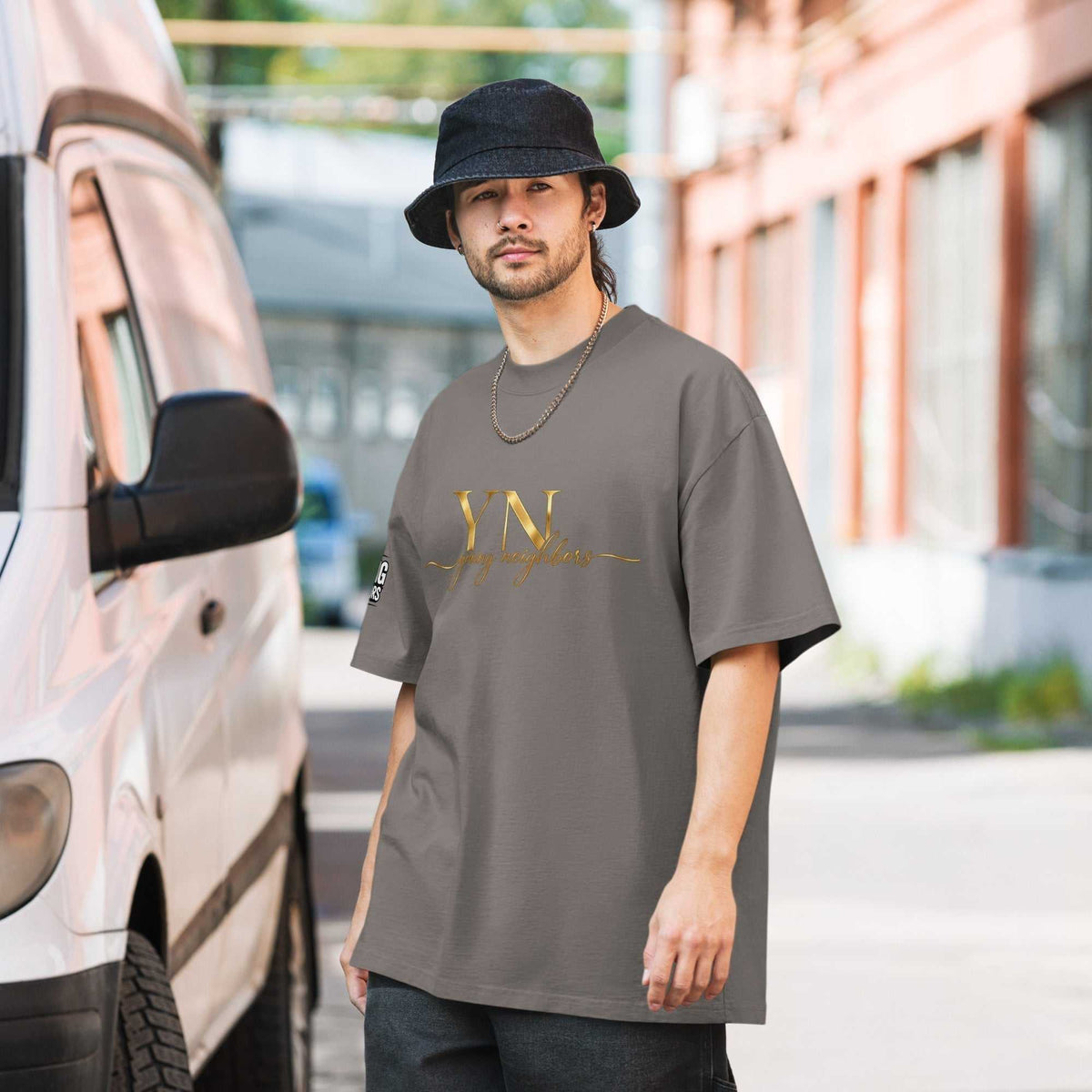 Black oversized signature tee laid flat showcasing relaxed fit and ribbed crew neckline