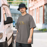 Black oversized signature tee laid flat showcasing relaxed fit and ribbed crew neckline