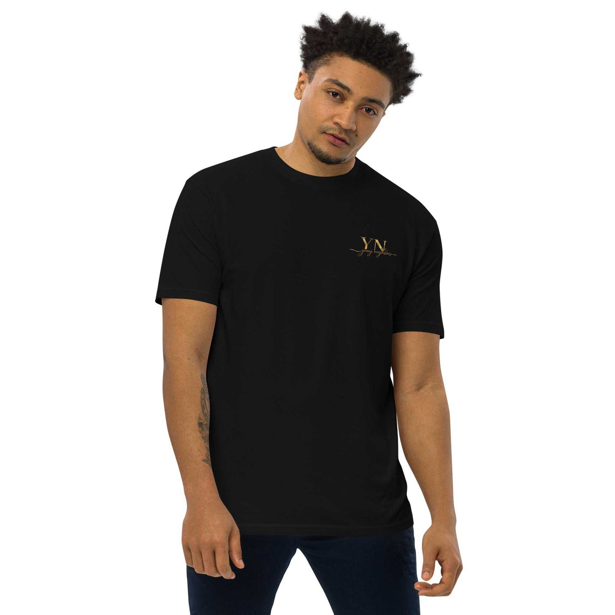 Premium Young Neighbors tee with metallic gold embroidered logo and 1 Timothy 4:12 reference on back