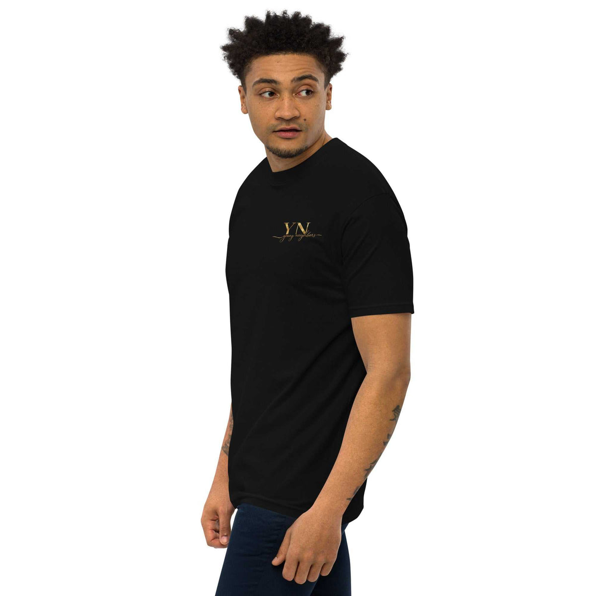 Premium Young Neighbors tee with metallic gold embroidered logo and 1 Timothy 4:12 scripture detail